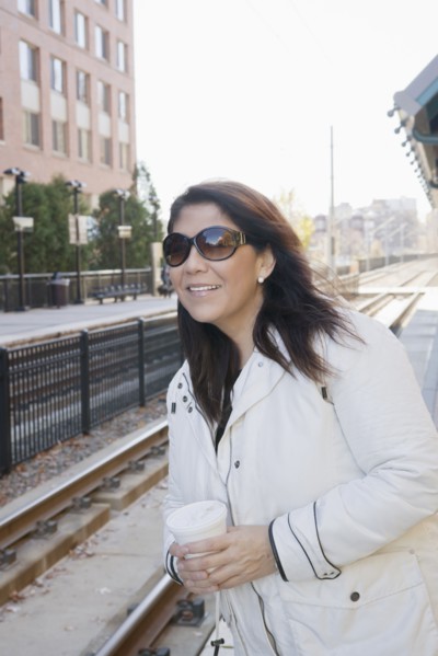 Hispanic woman waiting for train