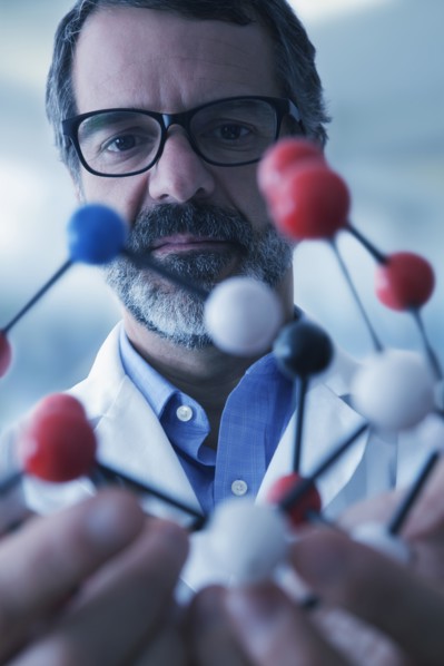 Hispanic scientist examining molecule model
