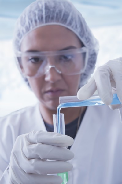 Hispanic scientist pouring liquid into test tube