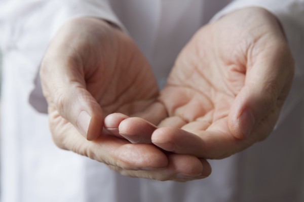 Cupped hands of Hispanic doctor