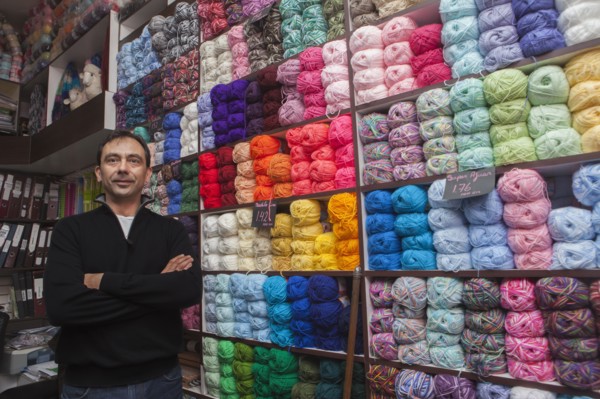 Mixed Race man posing at yarn store