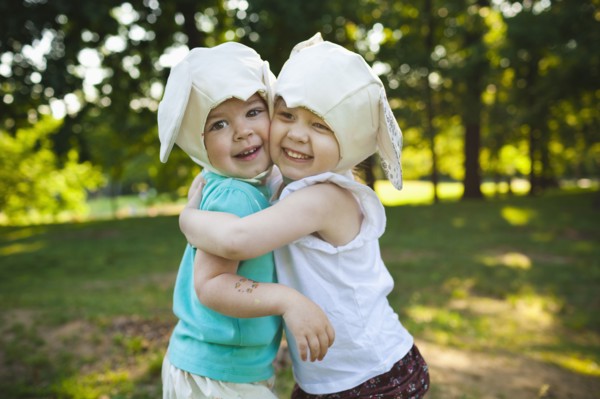 Smiling girls in mouse costume hugging