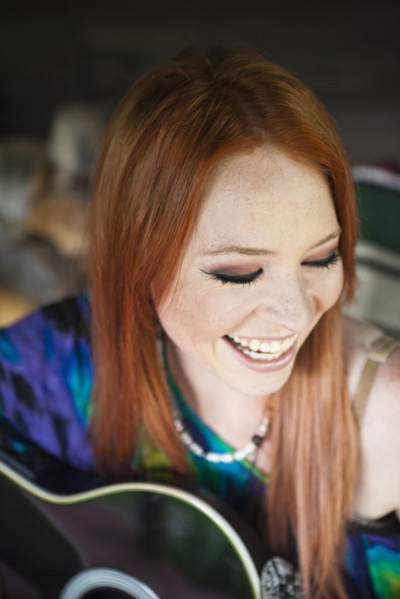 Caucasian woman playing guitar