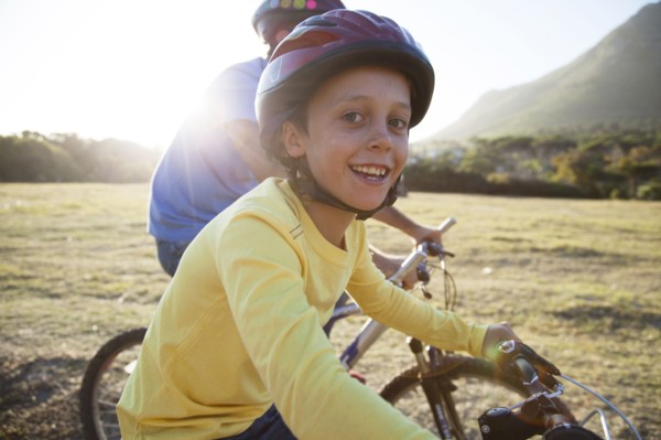 Caucasian father and son riding bicycles
