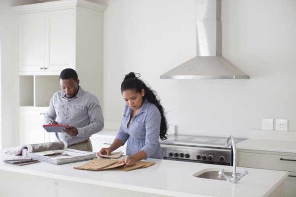 Couple examining fabric swatches in new home