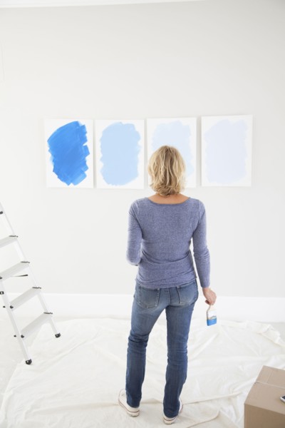 Caucasian woman examining paint samples in new home