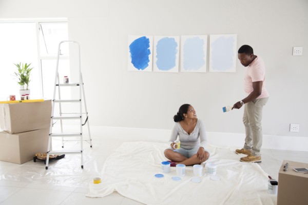 Couple examining paint samples in new home