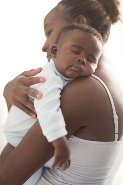 Close up of Black mother holding sleeping baby