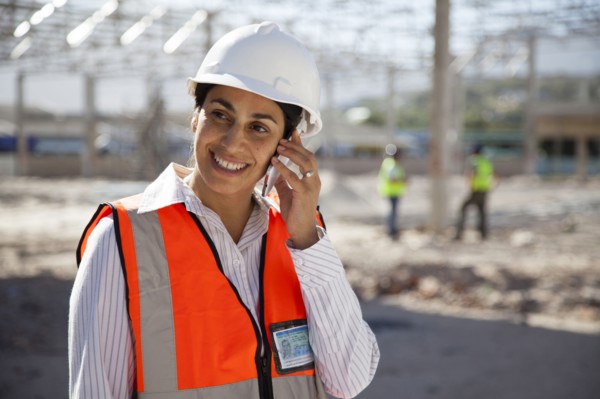 Architect talking on cell phone at construction site