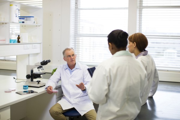 Scientists talking in laboratory
