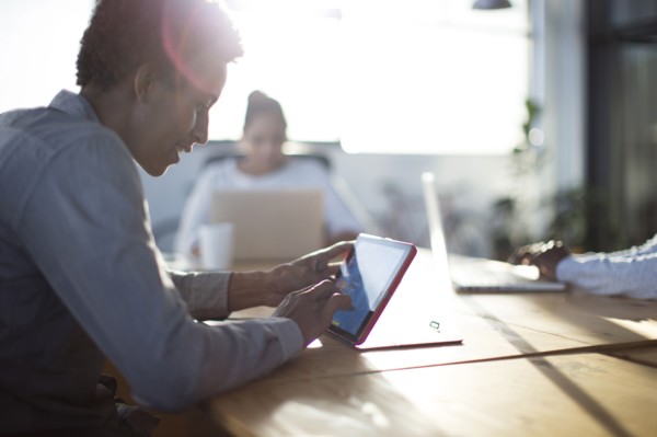 Mixed race business people using technology in office
