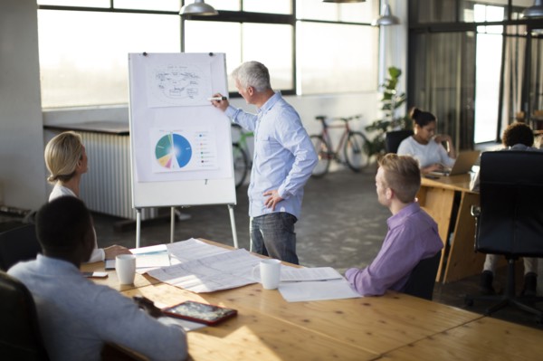 Businessman giving presentation in office meeting
