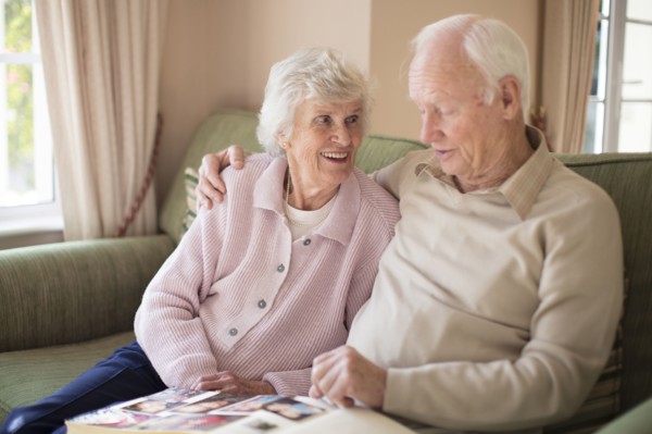 Older Caucasian couple looking at photo album