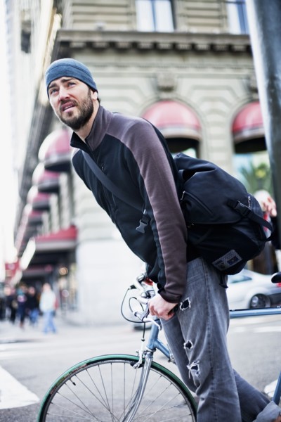 Caucasian man riding bicycle in city