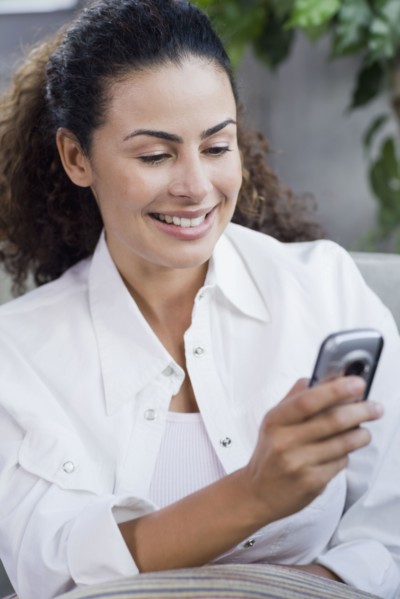 Dominican woman looking at cell phone