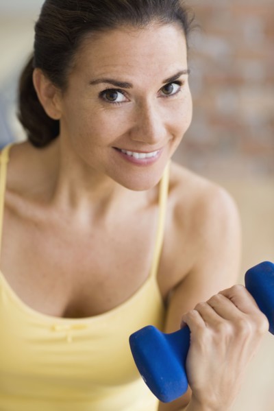 Hispanic woman exercising with dumbbells