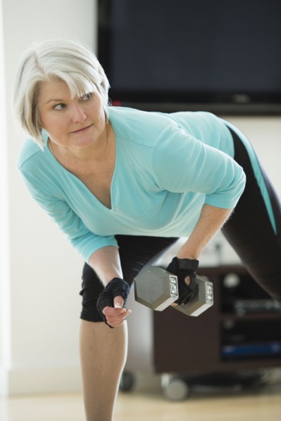 Caucasian woman exercising with hand weights