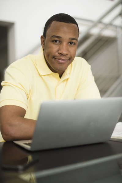 Mixed race businessman using laptop