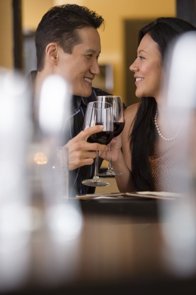 Couple toasting with red wine in restaurant