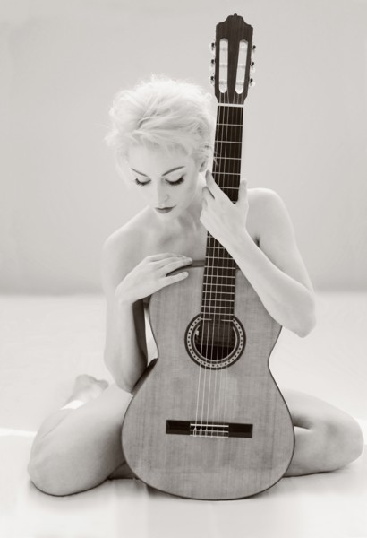 Nude Cuban woman holding guitar