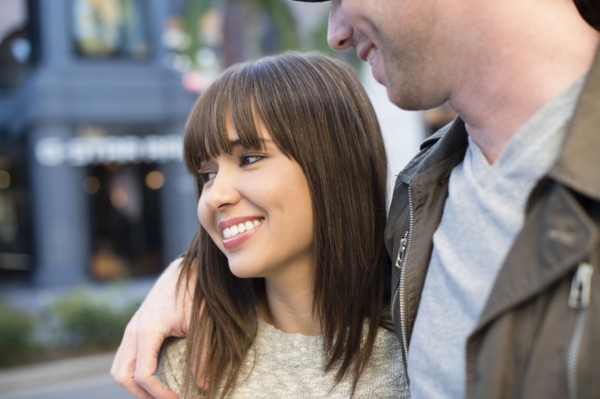 Smiling couple walking on city street