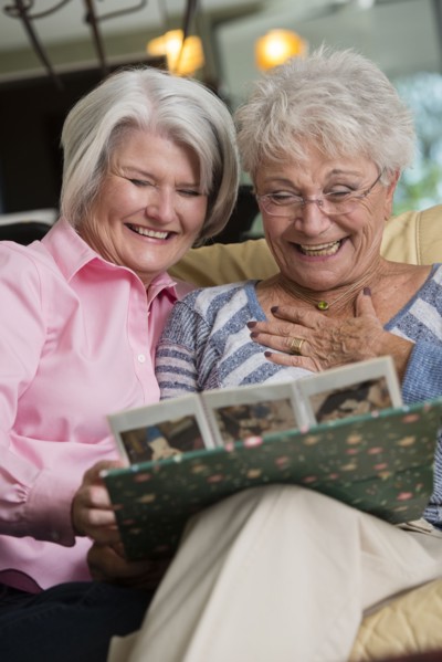 Senior Caucasian women looking at photo album