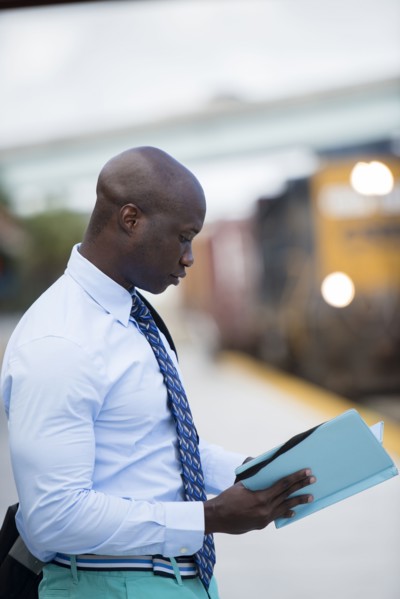 African American businessman waiting for train