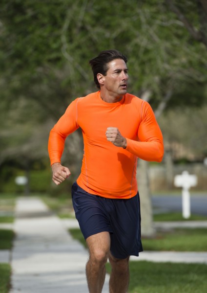 Caucasian man jogging on suburban street