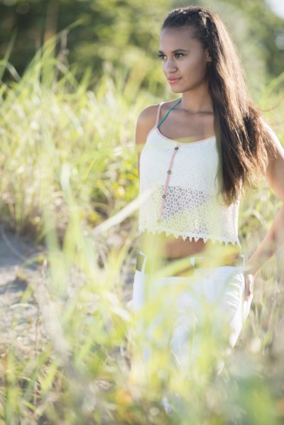 Mixed race woman walking in tall grass