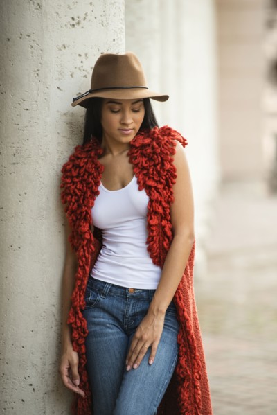 Black woman leaning on pillar