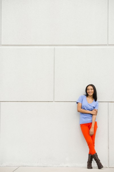 Black woman smiling near concrete wall
