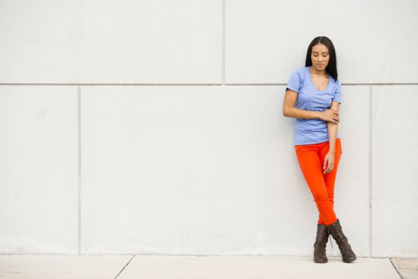 Black woman standing near concrete wall