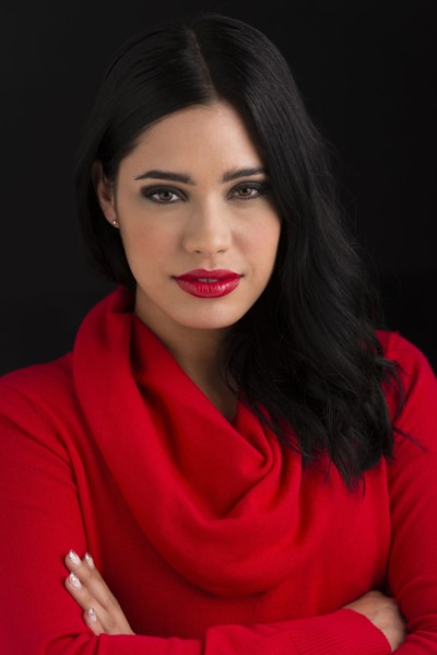 Glamorous Hispanic woman with arms crossed