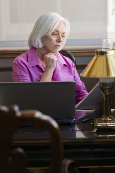 Caucasian businesswoman working at office desk