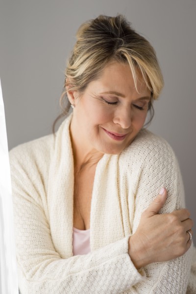 Caucasian woman wrapped in warm sweater