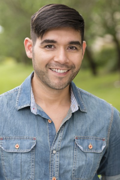 Hispanic man smiling outdoors