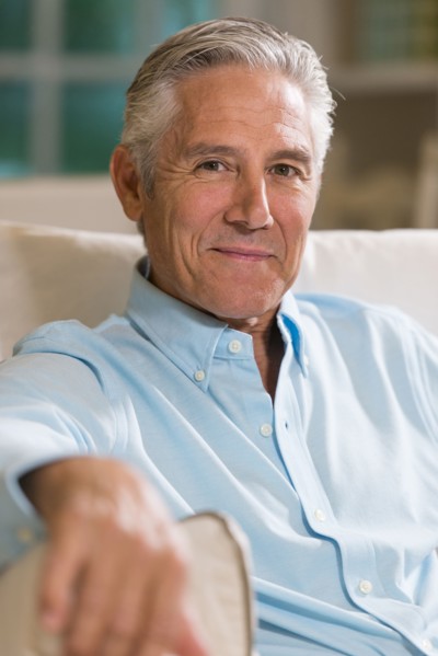 Caucasian businessman smiling on sofa