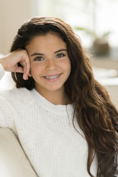 Mixed race girl smiling on sofa
