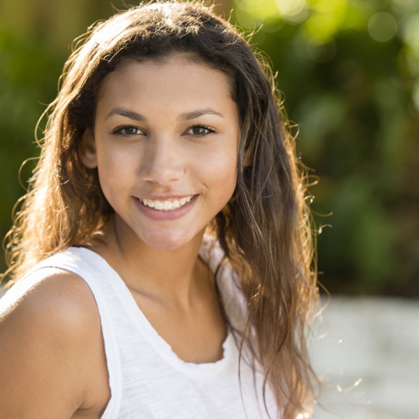 Mixed race teenage girl smiling outdoors
