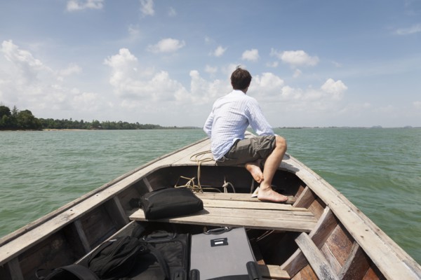 Caucasian businessman riding in boat