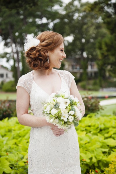 Smiling Caucasian bride holding wedding bouquet