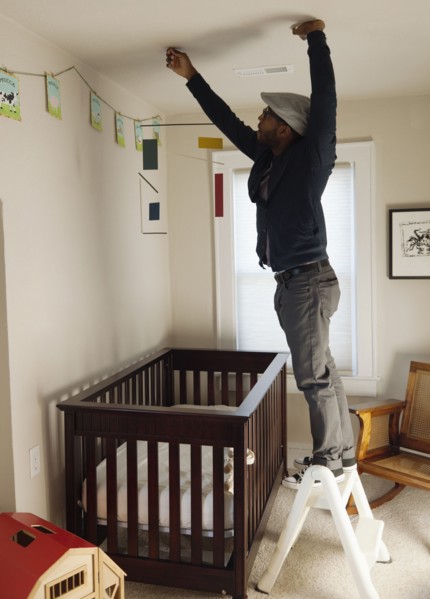 Black man decorating bedroom