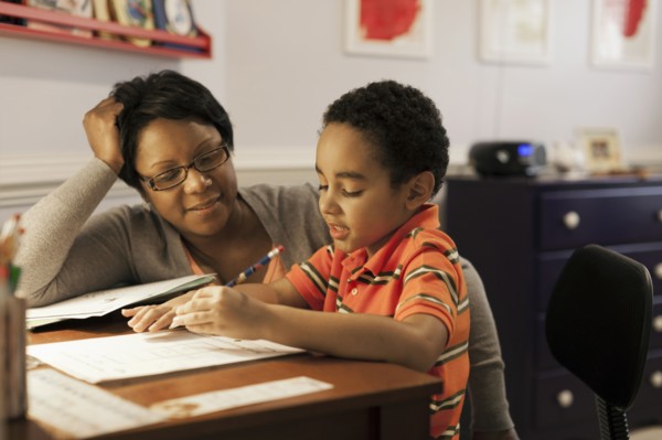 Mother helping son with homework