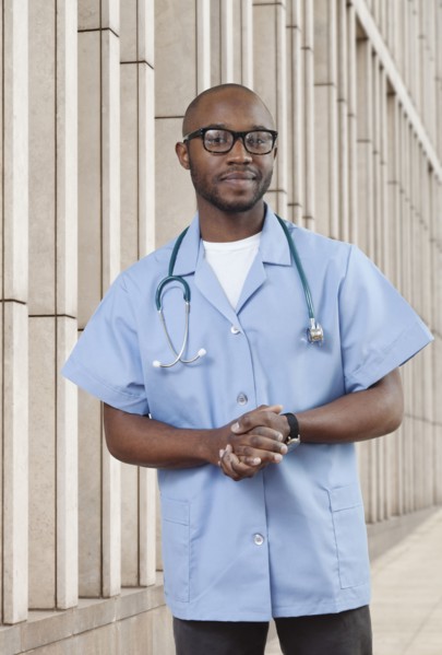 Black doctor standing on city street