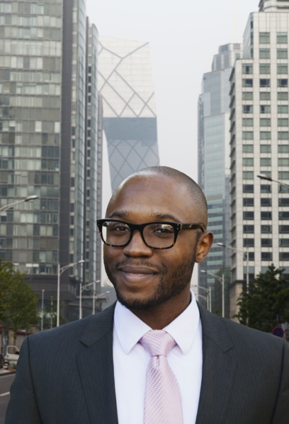Black businessman smiling on city street