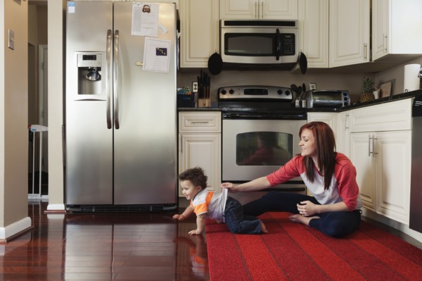 Mother and baby playing in kitchen