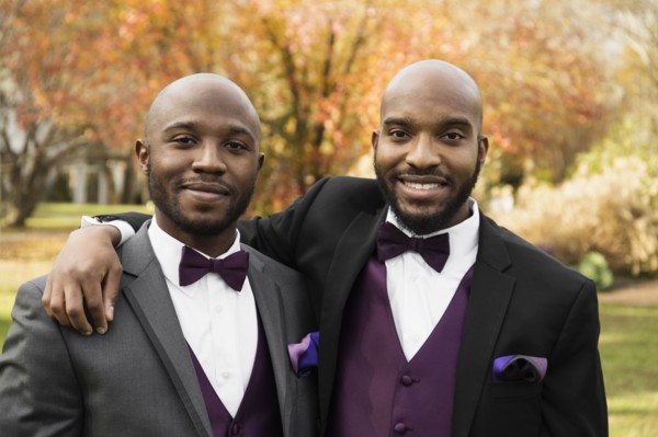 Black groom and best man posing at wedding