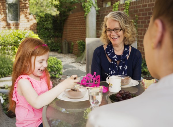 Caucasian family eating together in backyard