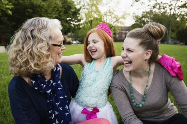 Three generations of Caucasian women sitting in park
