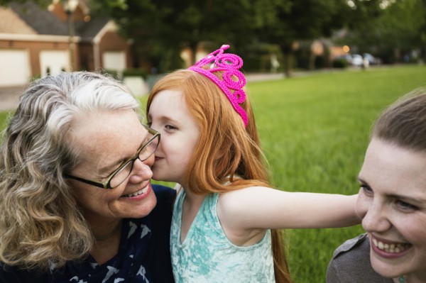 Three generations of Caucasian women sitting in park